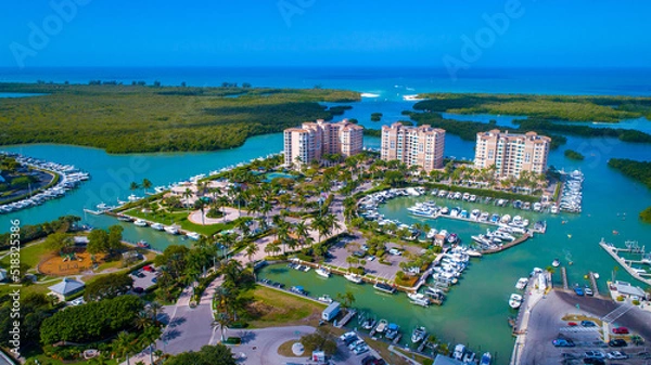 Fototapeta Aerial Drone Photo Showing a Pass from the Bay to the Gulf of Mexico in Naples, Florida with Real Estate in the Foreground