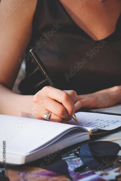 Obraz person writing on a notebook