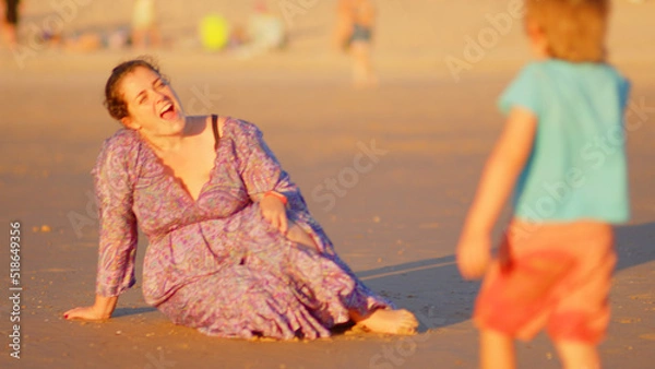 Fototapeta Wonderful family - father, mother and 4 sons (1-8 years old) - walk along one of the most beautiful beaches of Cádiz at sunset - they love and hug each other, look after their children