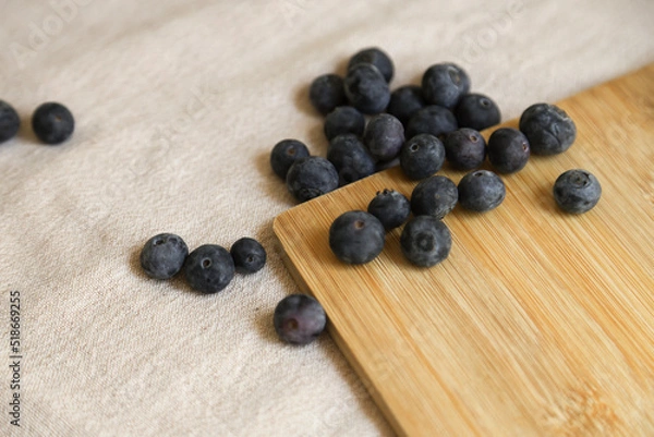 Fototapeta Fresh blueberries on wooden table close up.Blueberries on rustic wood table.Concept for healthy eating. Antioxidant organic superfood. 