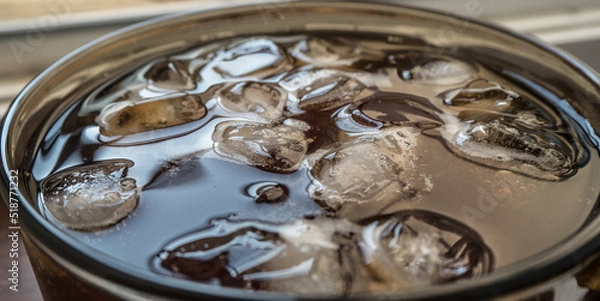 Obraz pieces of ice on the surface of the water in a mug close-up