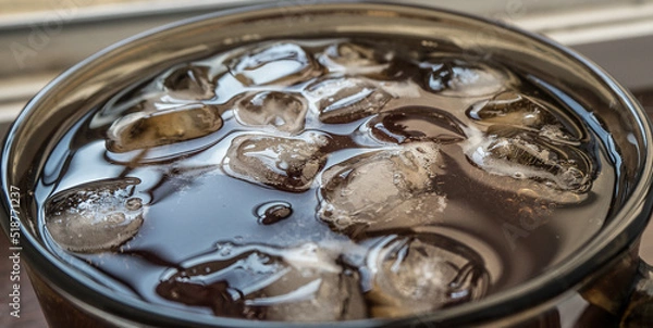 Obraz pieces of ice on the surface of the water in a mug close-up