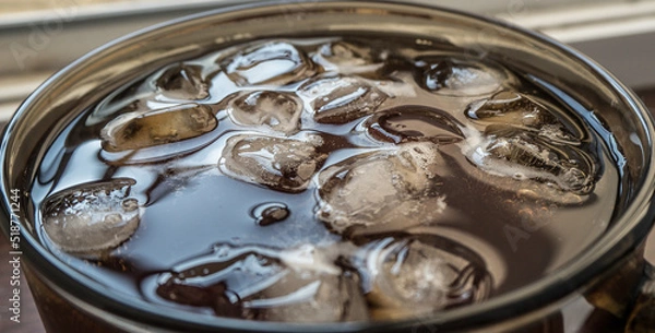 Obraz pieces of ice on the surface of the water in a mug close-up