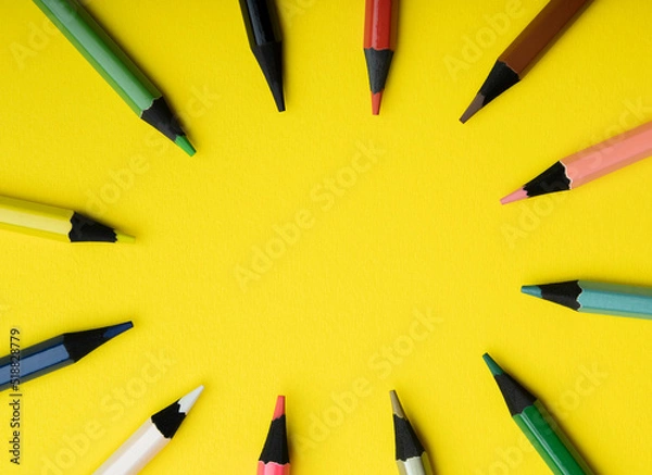 Fototapeta colored pencils on a yellow background