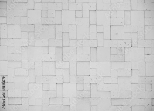 Fototapeta embossed stone tile wall with geometric patterns as colorless black and white background	