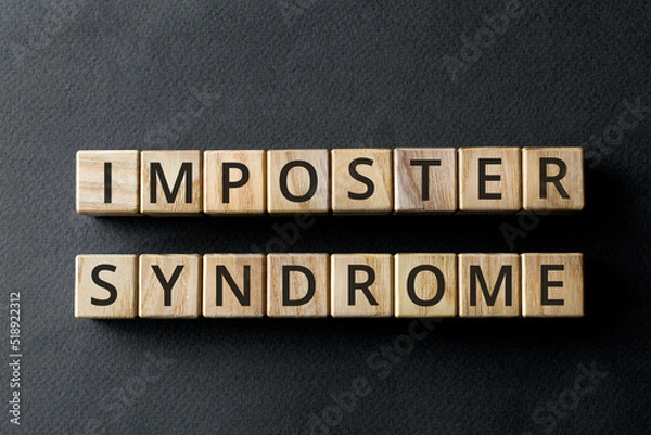 Fototapeta Impostor syndrome - phrase from wooden blocks with letters, psychological pattern inadequate incompetent Impostor syndrome concept, gray background