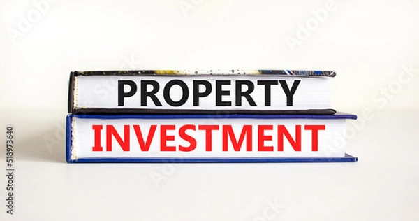 Fototapeta Property investment symbol. Concept words Property investment on books on a beautiful white table white background. Business Property investment concept. Copy space.