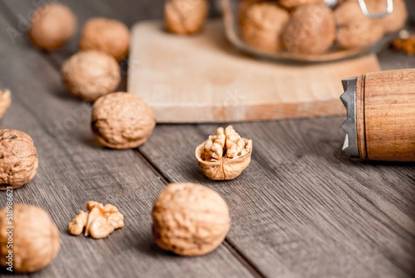 Fototapeta Walnuts kernels on wood desk with detail background,  walnut on wood kitchen underlay.