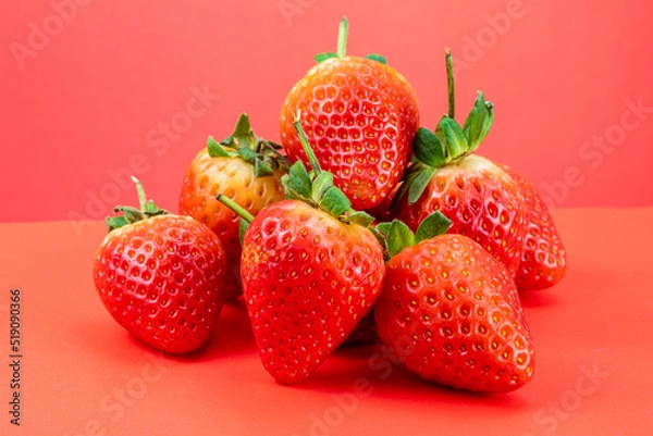 Obraz Strawberry isolated in red background 