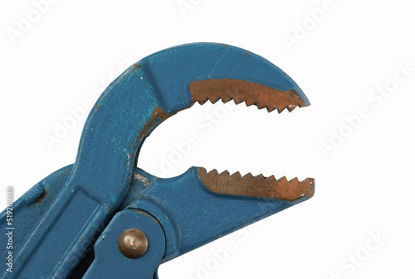Fototapeta Old adjustable wrench with rust stains. Pipe wrench on a white background. Adjustable spanner close up with no shadows. Blue monkey wrench for plumbing work. Images for design