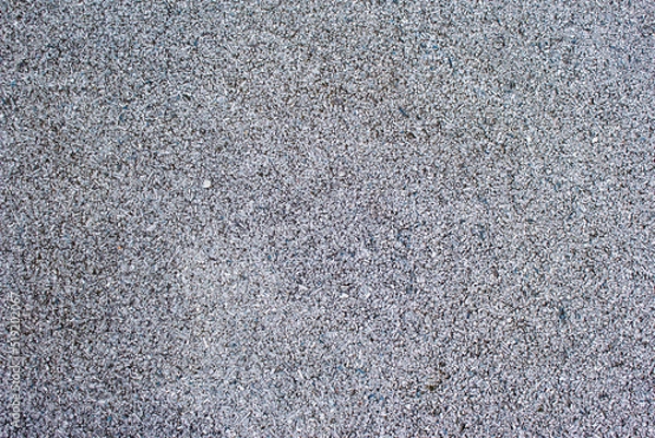 Fototapeta Rubber coating pattern of sports fields and tracks. Fine grey rubber chip. Safe to play sports. Coverage for children's playground. Texture of a covering for a sports ground.