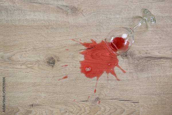 Obraz Glass of red wine fell on laminate, wine spilled on floor.