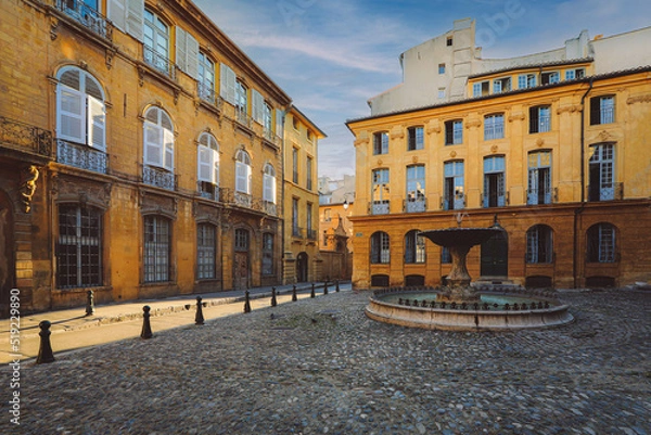 Fototapeta View of provence typical city Aix en Provence with old house facade and famous old fountain in the morning