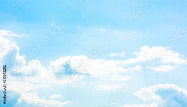 Fototapeta A vast light blue sky with freedom shape of fluffy clouds floating over the air. Soft and pure cloudy in sunny day, calm and tranquil nature scene. Abstract background of natural cloudscape.