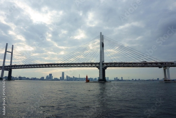 Fototapeta View of bridge against cloudy sky. Impressive Yokohama bay bridge over Tokyo Bay