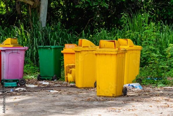 Fototapeta yellow bin Several plastic bins are left in the garbage collection area, causing pollution.