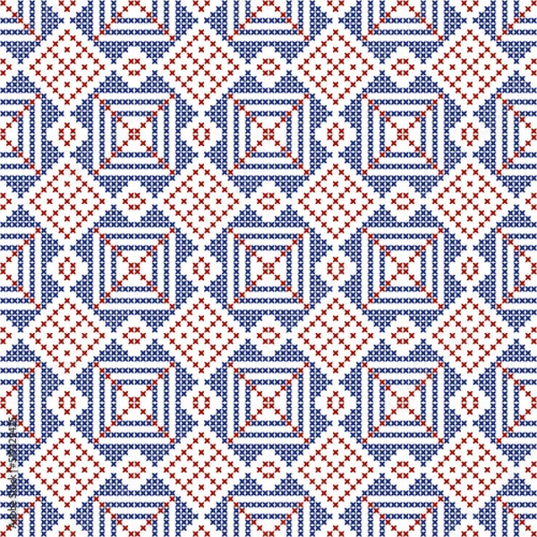 Fototapeta Scandinavian cross-stitch snowflake design, red and blue squares and rhombuses, seamless pattern