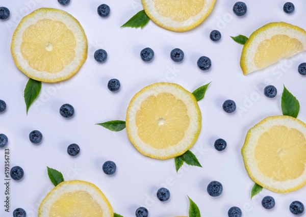 Obraz background of blueberries and lemon slices on a white background - the concept of a healthy diet. Summer bright food fruit background, food design