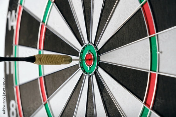 Fototapeta Dart for playing darts hitting exactly center target.