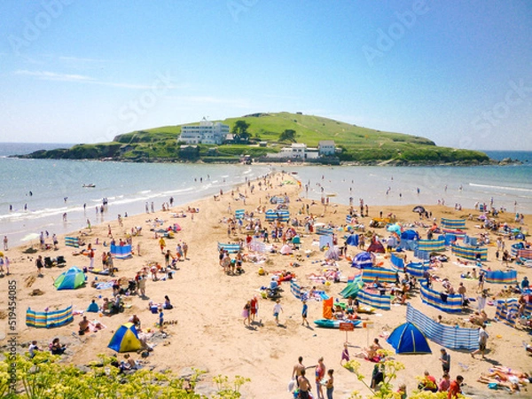 Obraz Tourists sunbathe in front of Burgh Island Hotel in Devon, England
