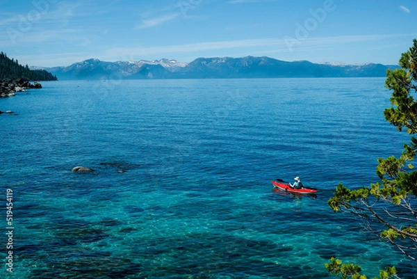 Fototapeta Tourist is kayaking in the lake with a very clear water. summer activity in lake tahoe.