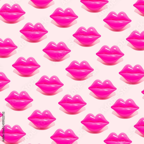 Fototapeta Creative pattern made with magenta lips figurine on pastel pink background. 80s or 90s romantic retro style aesthetic idea. Valentines day concept with kisses.