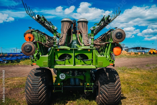 Fototapeta Row seed drill grain. Seed sowing device. Agricultural activity. Modern modified agricultural seeder and soil fertilization device as a trailed implement 