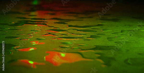 Fototapeta Beautiful macro photo of water drop reflection, lying on surface, front view. Close up of liquid with side lighting from displays.