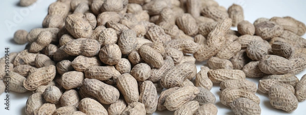 Fototapeta Peanuts background made up of salted peanuts in their shells