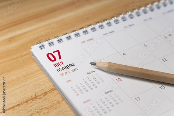 Obraz Jul month 2022 Calendar page with pencil business planning concept on wooden background