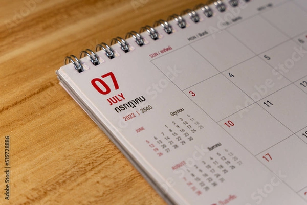 Obraz Jul month 2022 Calendar page on wooden background