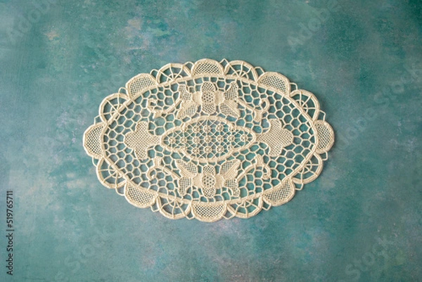 Obraz A single lacy doyley shot from above on a green textured background, space for text