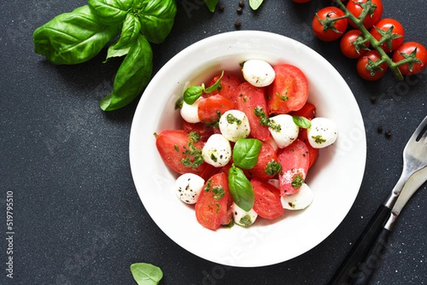 Fototapeta Italian appetizer caprese. Classic caprese salad with tomatoes and mozzarella