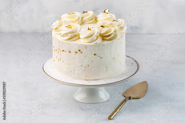 Fototapeta White cake on cake stand on the white background