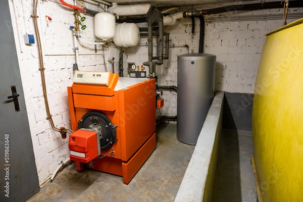 Fototapeta Old oil heating system with oil tank and hot water tank in the basement of a family house - heating with fossil fuels