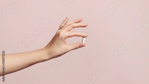 Obraz Hand holding the supplements on pink background