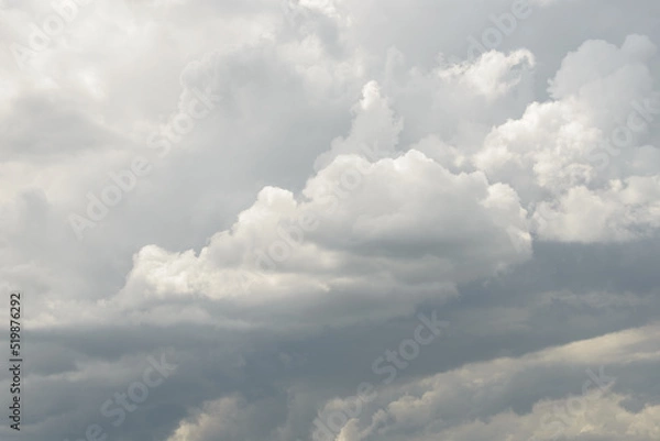 Fototapeta White big fluffy clouds. Natural scenic abstract background. Weather changes backdrop. Sky filled with voluminous clouds.
