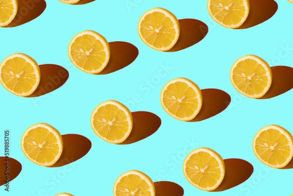 Fototapeta Lemon pattern on a light blue background. Pop art design, creative citruses. Yellow lemon, minimal flat style.