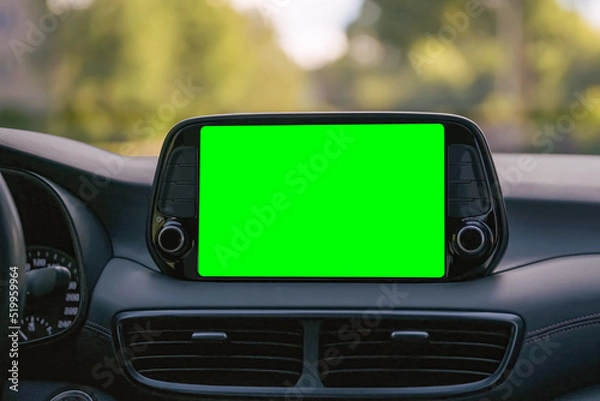 Fototapeta Close up display with green screen on car panel, car driving with navigation concept, blank screen dashboard.