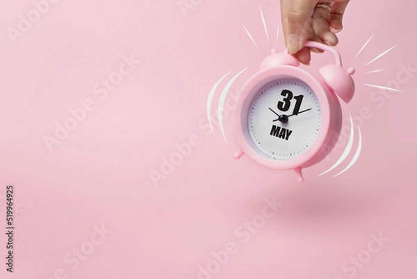 Fototapeta May 31st . Day 31 of month, Calendar date. The morning alarm clock jumping up from the bell with calendar date on a pink background. Spring month, day of the year concept.