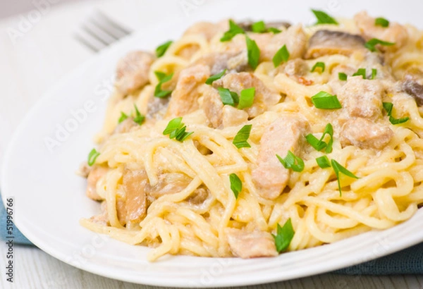 Fototapeta Spaghetti with meat and mushrooms in a creamy sauce