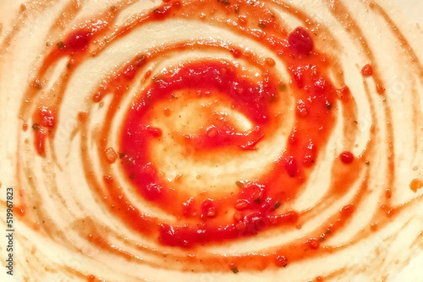Fototapeta The process of cooking pizza. Circles of tomato paste on the rolled out dough