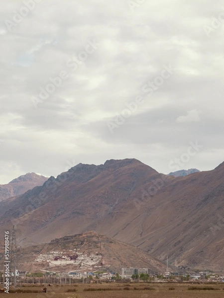 Obraz Ancient Tibetan palace on rocky barren mountains