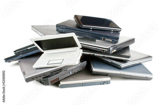 Obraz Stack of different sized and aged laptops, isolated