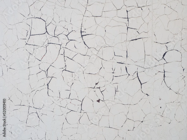Fototapeta Texture of concrete wall with peeling white paint. Concrete wall with cracked paint texture. Full screen photo. Not seamless texture
