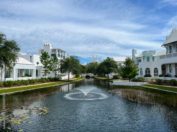 Fototapeta A walking path with water feature and homes in Alys Beach, Florida.