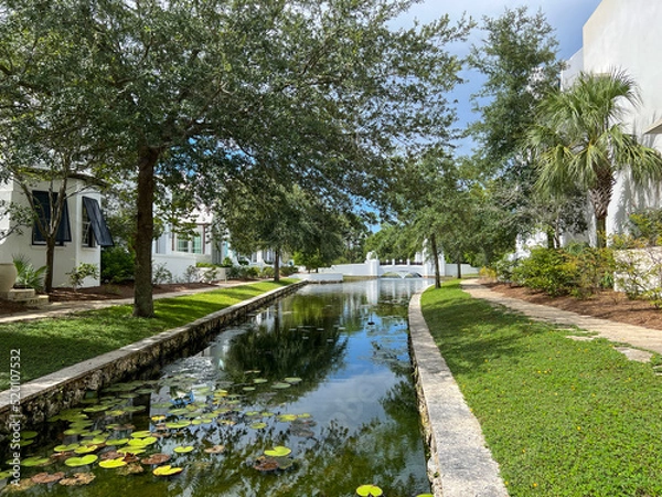 Fototapeta A walking path with water feature and homes in Alys Beach, Florida.