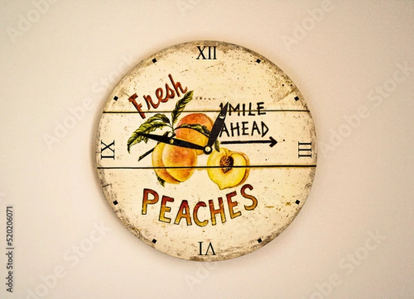 Fototapeta Retro clock with text on a wall