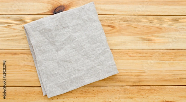 Fototapeta Empty canvas napkin top view on wooden desk