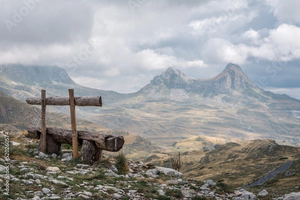 Fototapeta Empty bench watching over a mountain range in Durmitor national park, Montenegro
